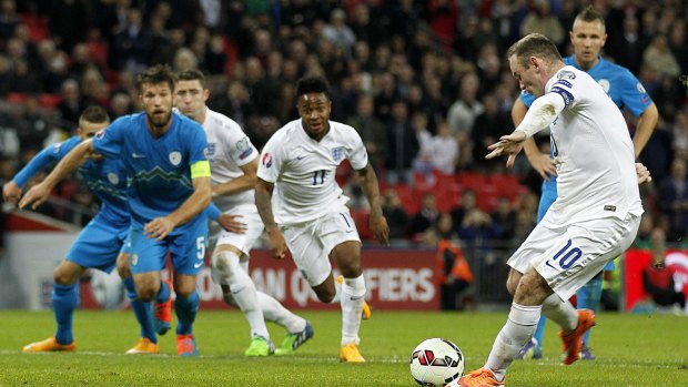 Spot kick: Wayne Rooney scores for England.