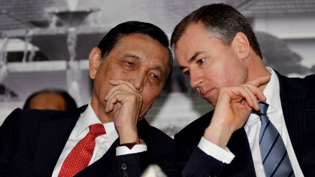Indonesia's Chief Security Minister Luhut Panjaitan, left, speaks to Justice Minister Michael Keenan in Jakarta in December.