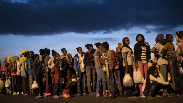 Fleeing multitudes: Hundreds of migrants from sub-Saharan Africa arrive at Augusta port in Sicily in September. 