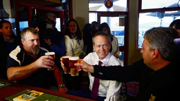Bill Shorten has a beer with Beaconfield Mine survivors Todd Russell and Brant Webb shortly after launching his election campaign in Tasmania.