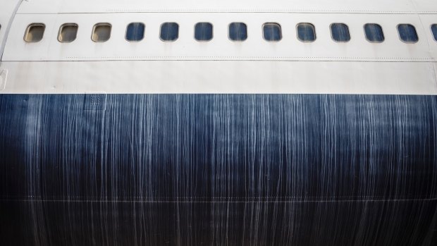 The fading lines of a Trans World Airlines Boeing 747's livery as it sits in storage.