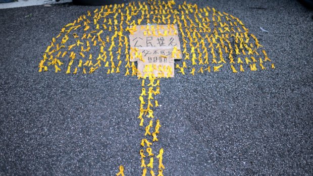 An umbrella made of yellow ribbons, both symbols of the pro-democracy protests in Hong Kong,  near the central government offices in 2014.   