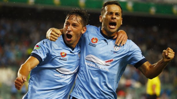 Magic number: Sydney forward Bobo (right) has already scored more than 10 goals this season - a target Filip Holosko has been set by coach Graham Arnold.