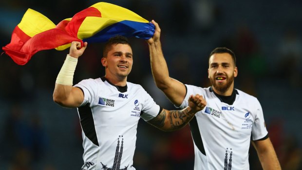 Valentin Calafeteanu and Madalin Lemnaru of Romania celebrate their victory over Canada at Leicester City Stadium on Tuesday.