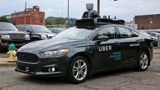 A self driving Uber car drives down River Road on Pittsburgh's Northside.