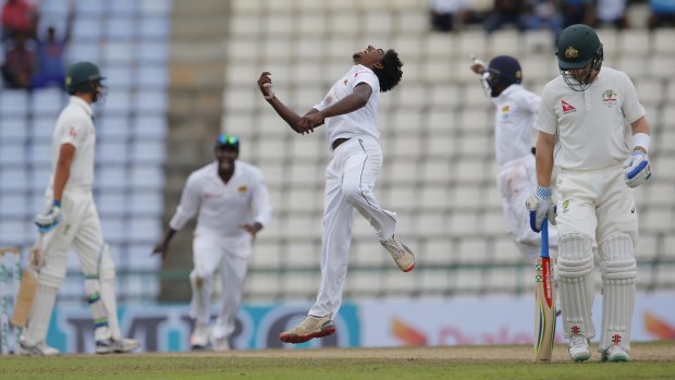 Sri Lanka's bowler Lakshan Sandakan celebrates the dismissal of Australia's Mitchell Starc.