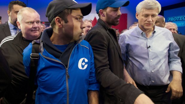 Stephen Harper finds himself a little close for comfort to notorious former Toronto mayor Rob Ford, left, at a campaign rally in the city at the weekend.