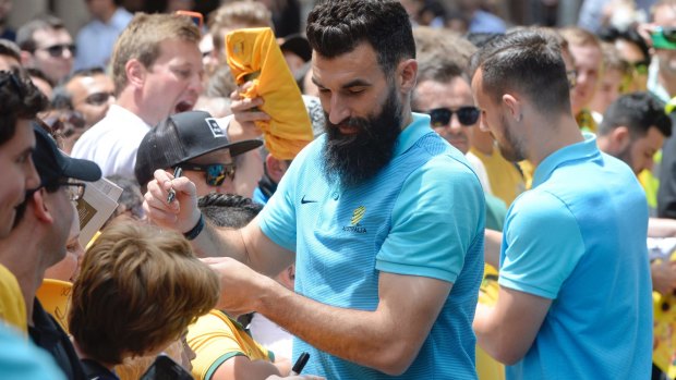 Celebration: Socceroos captain Mike Jedinak with fans at Martin Place.