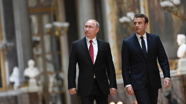 French President Emmanuel Macron and Vladimir Putin in the Galerie des Batailles at Versailles, France, last month.