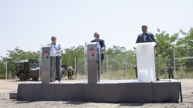 Hungarian interior minister Sandor Pinter (centre) and Defence Minister Csaba Hende (left) at press conference next to the first portion of the fence, on Wednesday.