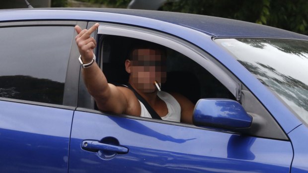 A man in Wentworthville gestures to the media on Wednesday.