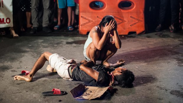 Jennilyn Olayres weeps over the body of her husband Michael Siaron after armed assailants in a motorcycle shot him in a main thoroughfare in Manila in July.