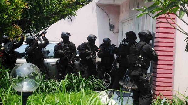 Armed anti-terror police conduct a raid at the house of a suspected Islamic State member at Petukangan district in Jakarta earlier this month.