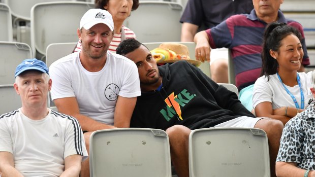 Sleepy: Nick Kyrgios watches his partner Ajla Tomljanovic of Croatia play during her first-round match against Destanee Aiava.