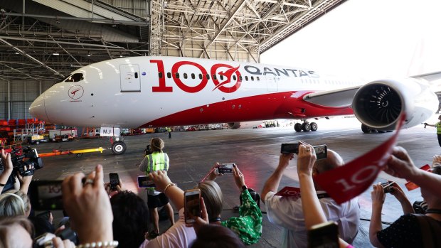 The flight arrives in Sydney where a celebration is held to mark Qantas' 100th year of service.