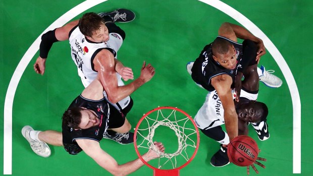 New Zealand's Akil Mitchell attempts to rebound against Majok Majok of Melbourne United.
