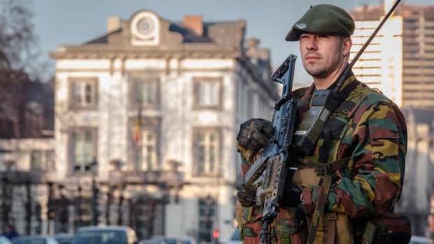 A Belgian commando patrols near the office of the prime minister in Brussels after a firefight in Verviers, Belgium, in January. The train gunman has been tentatively linked to a terror cell in Verviers.