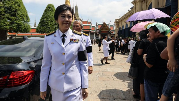 Yingluck Shinawatra, ousted prime minister of Thailand, leaves a royal bathing ceremony the day after the announcement of the death of Thai King Bhumibol Adulyadej on October 14.