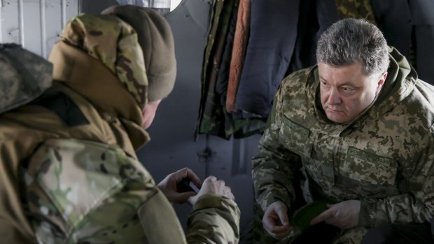 Ukrainian President Petro Poroshenko (right) talks to his armed forces chief Viktor Muzhenko aboard a helicopter as they travel to Artemivsk to meet servicemen on Wednesday. 