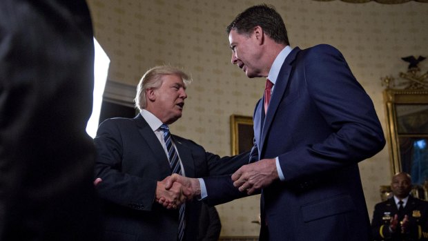 President Donald Trump greets then-FBI director James Comey with a handshake back in February.