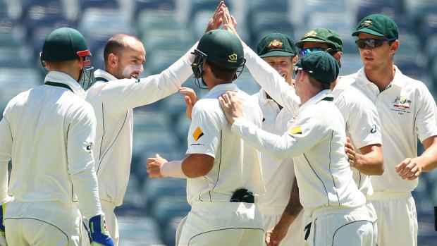 Nathan Lyon and Steven Smith celebrate with each other after taking the wicket of New Zealland's Mark Craig.