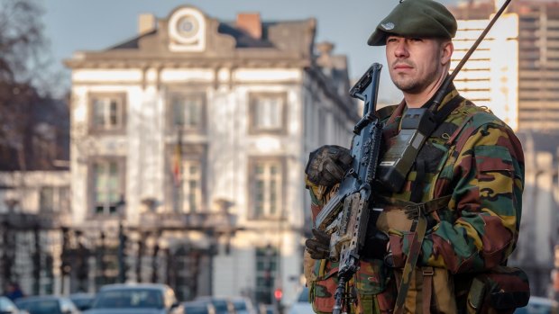A Belgian commando patrols near the office of the prime minister in Brussels after a firefight in Verviers, Belgium, in January last year. The train gunman has been tentatively linked to a terror cell in Verviers.