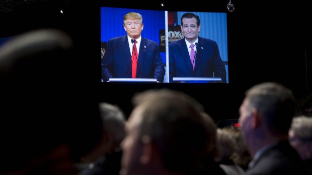 Donald Trump, left, and Senator Ted Cruz, on a television screen during Thursday's Republican presidential candidate debate.