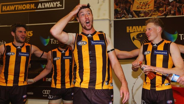 Hawks hero Jack Fitzpatrick sings the club song after the last-gasp win against Collingwood on Sunday. 