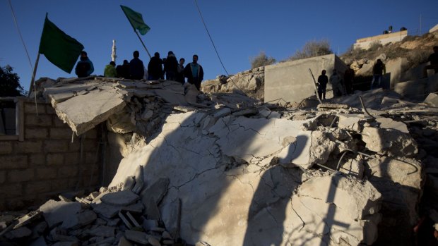 Palestinians inspect a house demolished by the Israeli army in the occupied West Bank village of Silwad, near Ramallah. The Israeli military said it had demolished the homes of four Palestinians who carried out deadly attacks against Israelis.