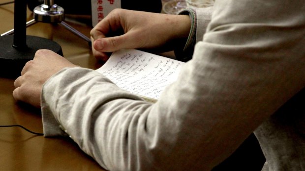 American student Otto Warmbier holds onto handwritten notes during Monday's press conference.