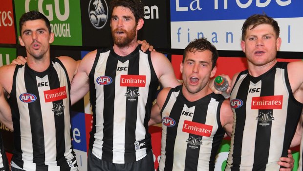 Scott Pendlebury, Tyson Goldsack, Jarryd Blair and Taylor Adams of the Magpies sing in the rooms after their win against the Hawthorn Hawks on May 20.