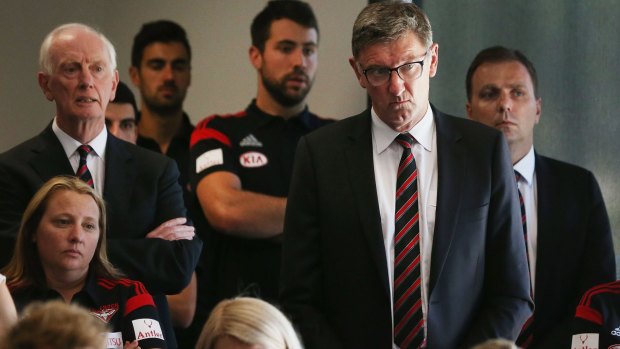 Marching on: Essendon legend Simon Madden (second right).