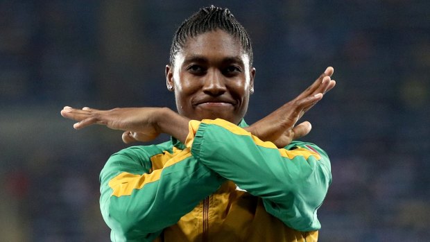 Caster Semenya brushes  the dust off her shoulders after the race.
