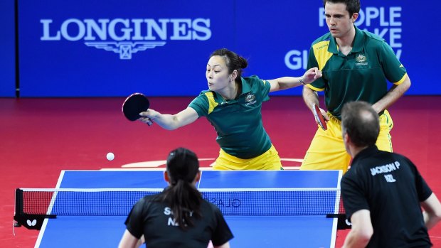 William Henzell (R) competes alongside Miao Miao in the mixed doubles competition.