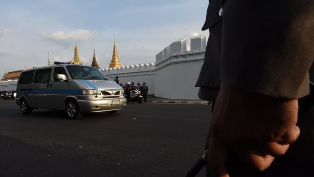 The car transporting the body of Thailand's King Bhumibol to the Grand Palace moves through the streets of Bangkok on Friday.