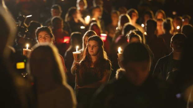 People gather for a candlelight vigil at Stewart Park in Roseburg after the shooting.