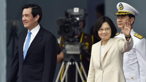 New President Tsai Ing-wen, right, waves beside former President Ma Ying-jeou on Friday.