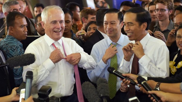Informal: Malcolm Turnbull and Joko Widodo take off their ties during a visit to Tanah Abang market in Jakarta in November 2015.