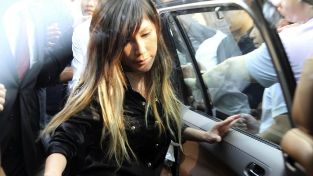 Singaporean pop music singer Ho Yeow Sun leaving court during the case against her husband. She was not charged but her husband was found guilty of diverting millions to support her career.