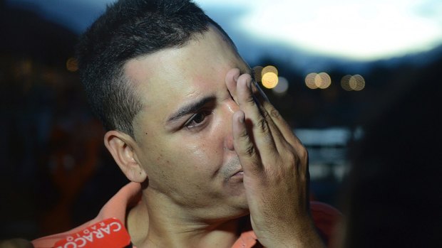 Gilberto Villegas, a ferry passenger, cries as he tells of two relatives missing, in Guatape.