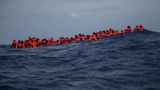 Sub-Saharan migrants wait to be rescued by aid workers of Spanish NGO Proactiva Open Arms in the Mediterranean Sea, about 24 kilometres north of Sabratha, Libya.