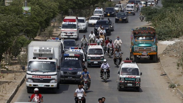Ambulances take bodies of attack victims to a hospital for autopsies in Karachi, Pakistan.