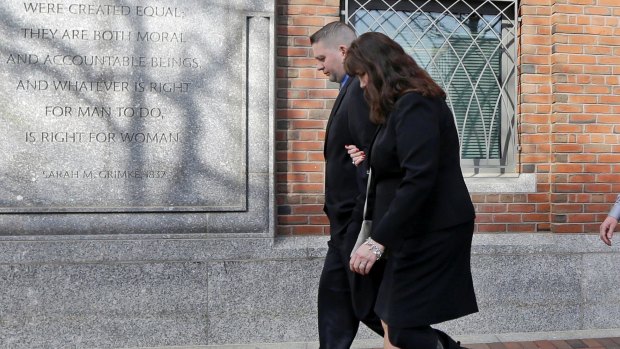 Boston Marathon bombing survivor Karen Rand walks from court in Boston.