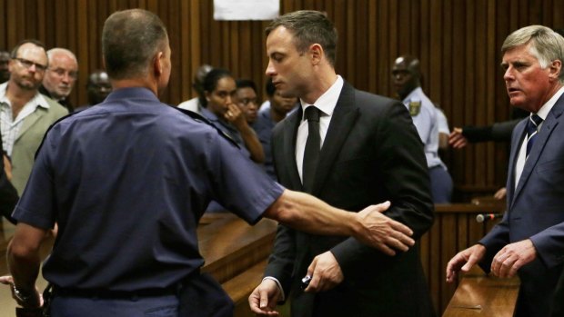 Oscar Pistorius is led out of court after he received a five-year prison sentence for culpable homicide.