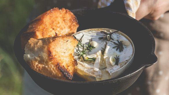 Campfire-baked camembert makes a tasty snack.