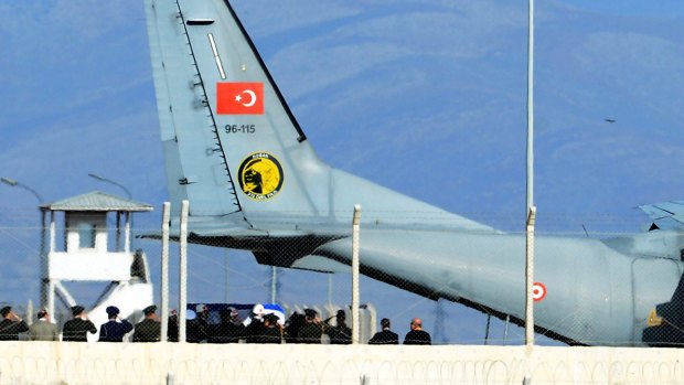 Turkish army officers salute as a Turkish honour guard carries the coffin of Russian pilot Lieutenant-Colonel Oleg Peshkov into a Turkish air force transport plane at Hatay airport, Turkey.