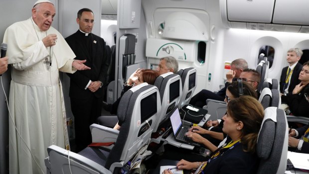 Pope Francis talks to journalists during a press conference on board the flight to Rome after a five-day visit to Colombia.