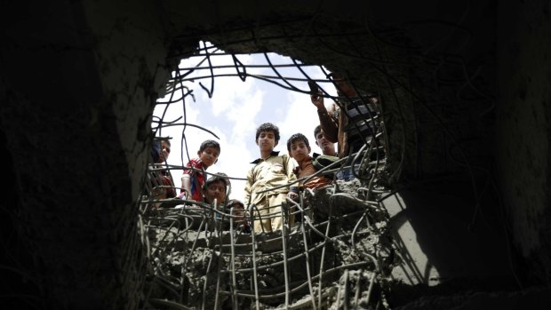 Boys look through a hole made by a Saudi-led airstrike on a bridge in Sanaa, Yemen. Egypt maintains channels of communications with Yemen's rebels, Iran, Iraq's Shiite-led government and Lebanon's Iranian-backed Hezbollah.
