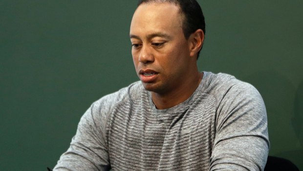 Under the spotlight: Tiger Woods, pictured at a book signing in May.