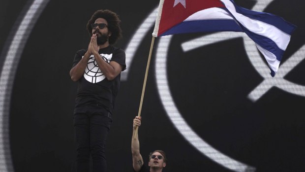 Diplo, of the US electronic music group Major Lazer, waves a Cuban flag next to fellow bandmate Jillionaire during a free concert at the Anti-Imperialist Park in front of the new US embassy in Havana on Sunday.